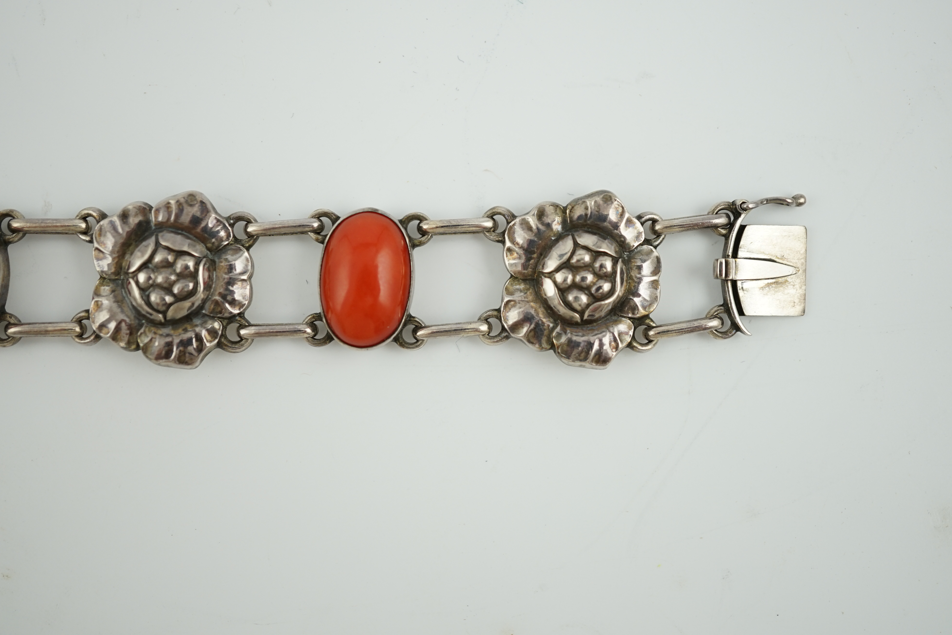 A George Jensen sterling silver and four stone cabochon coral set bracelet